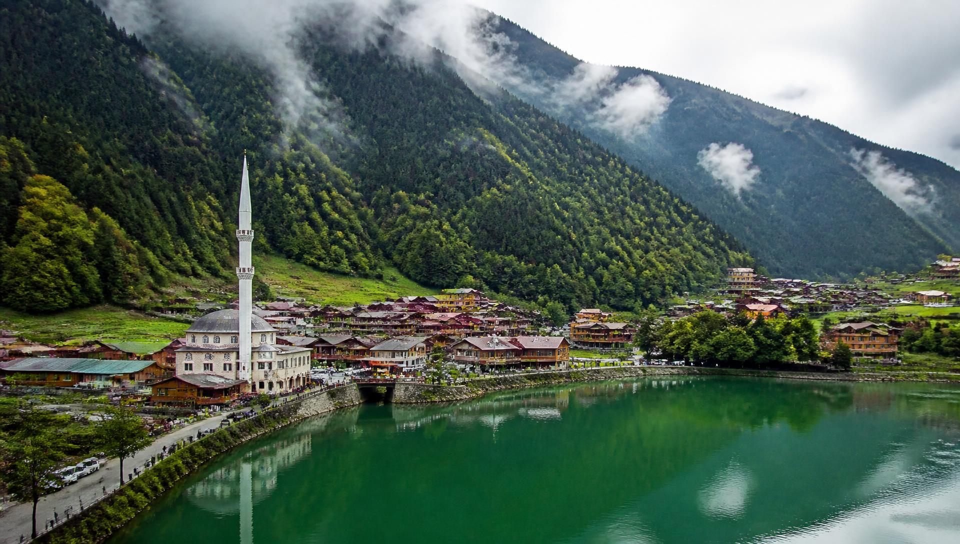 Uzungöl lake and its mosque below misty green mountains in Trabzon